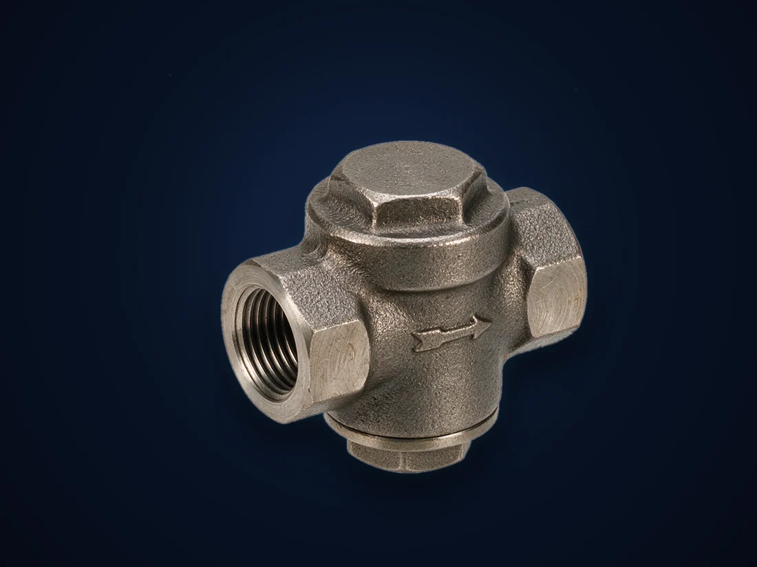 A cast steam trap with threaded inlet and outlet and an inspection cap