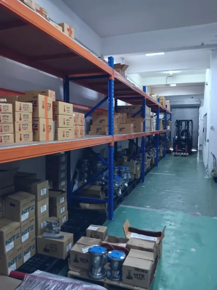 The Optimus Distributor warehouse at Jalan Tiara 3, racking stacked with valve cartons